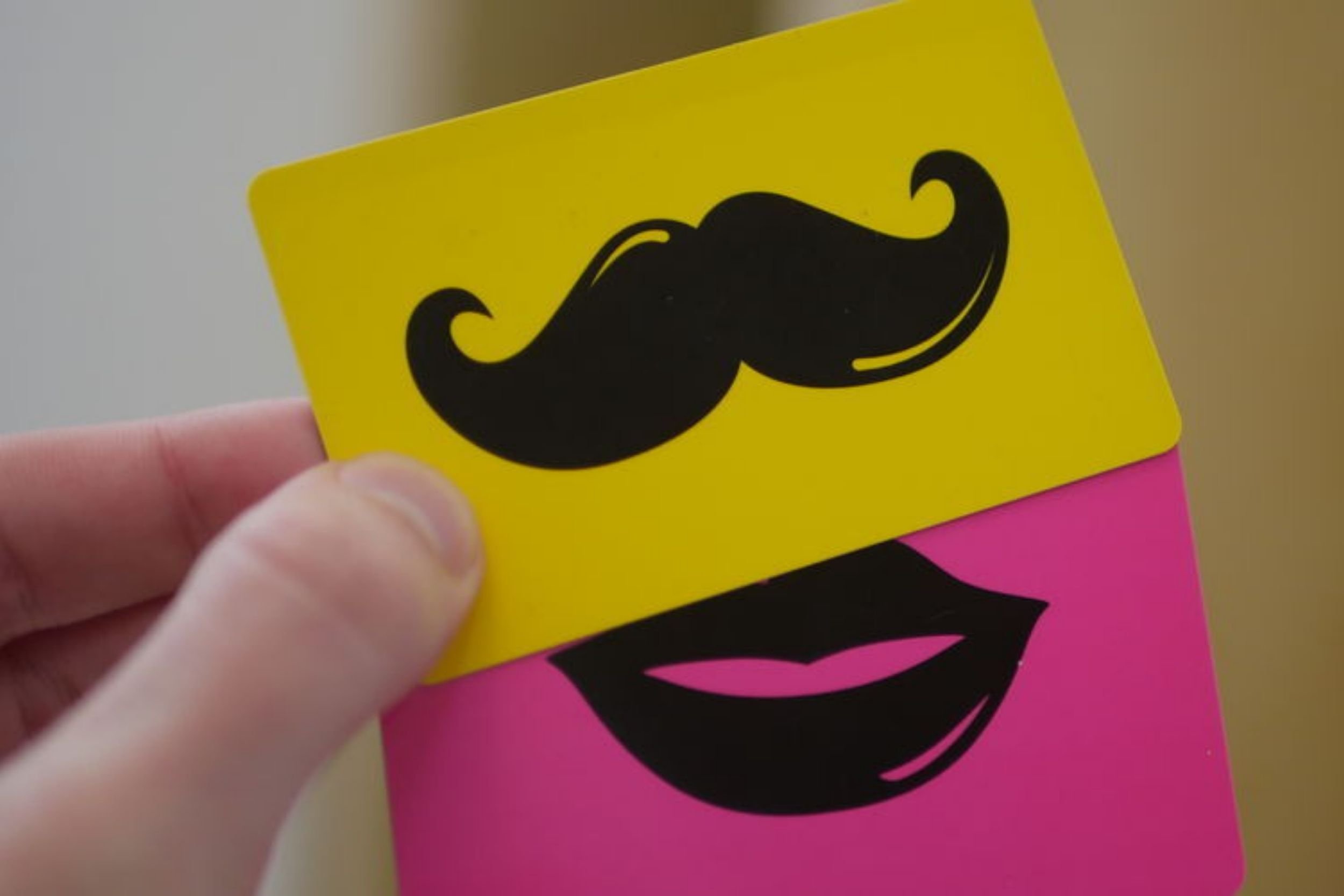 a yellow and a pink bespoke access control cards with a moustache and lip motifs