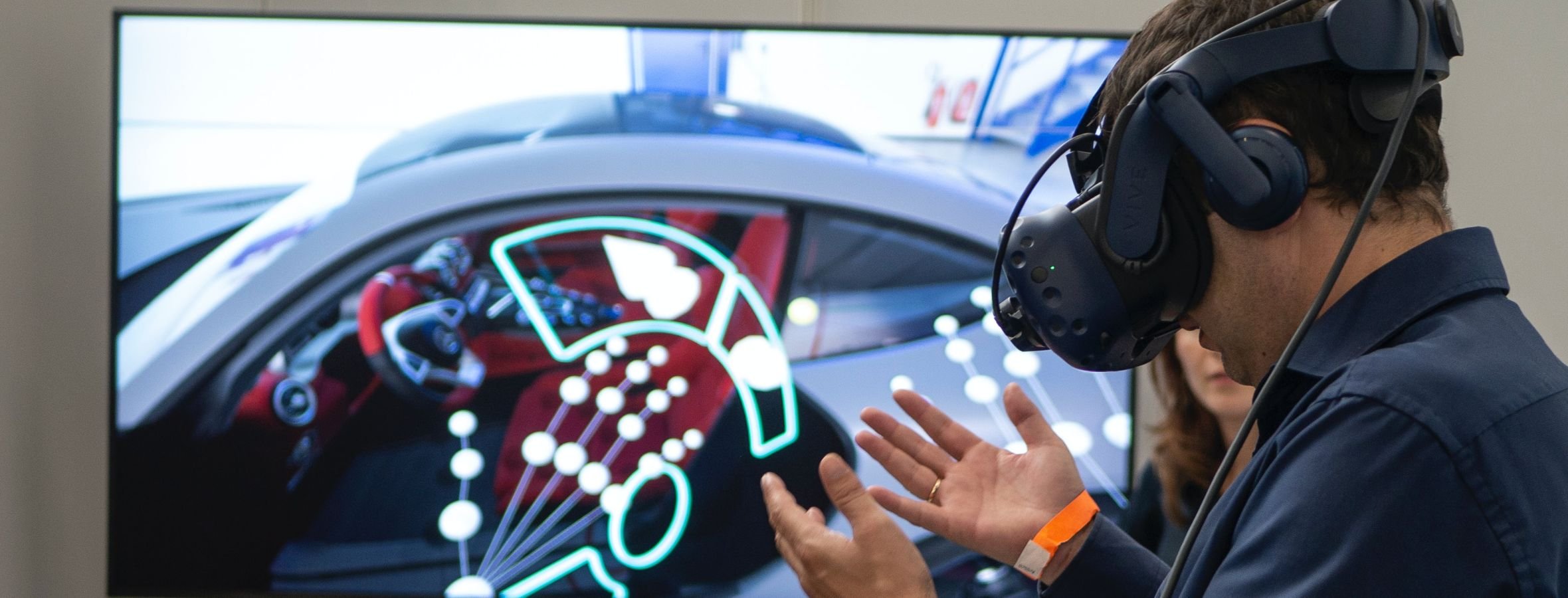 A man using a VR headset for a virtual car experience