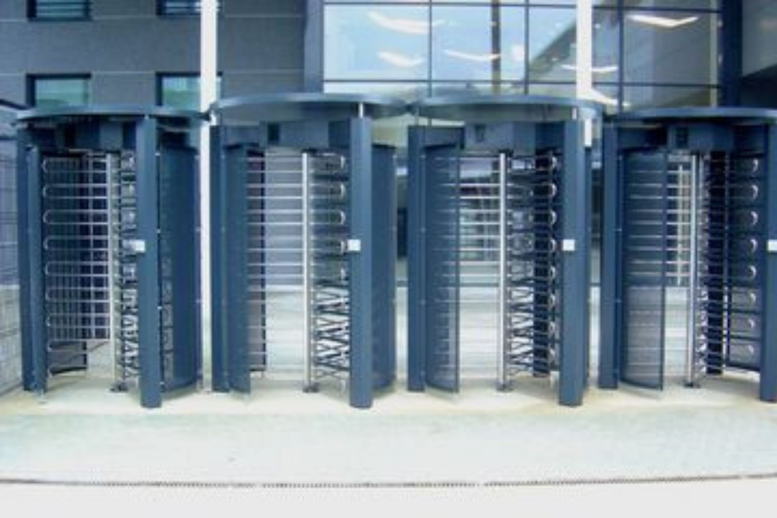 Full-height turnstile gates outside an office facility