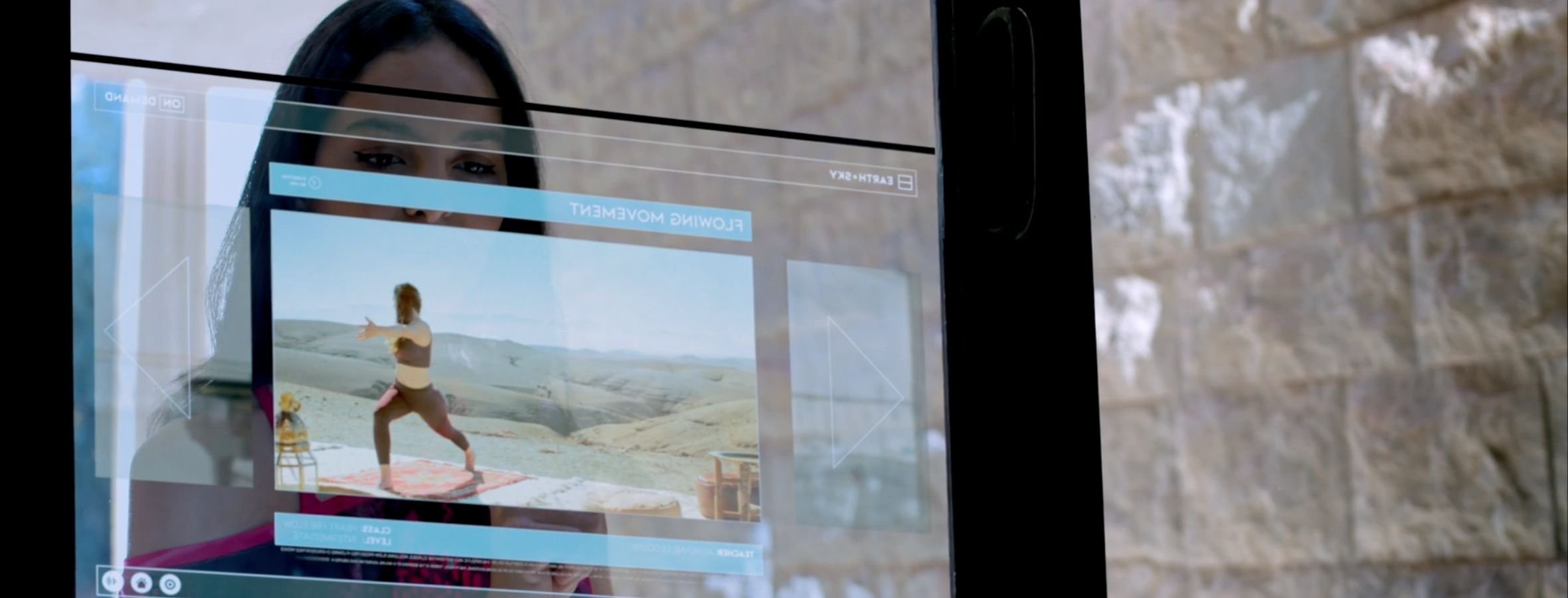 A hotel guest using an on demand touchscreen to select a virtual fitness class