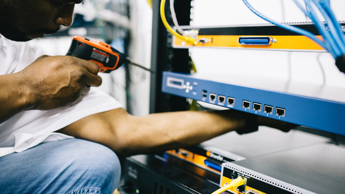 engineer working on nterworking and connectivity rack